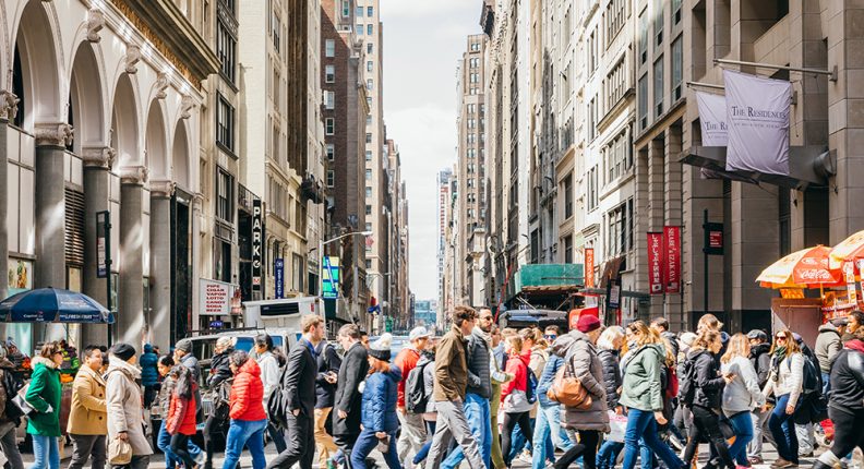Pedestrians in a crosswalk in the Garment District in NYC
